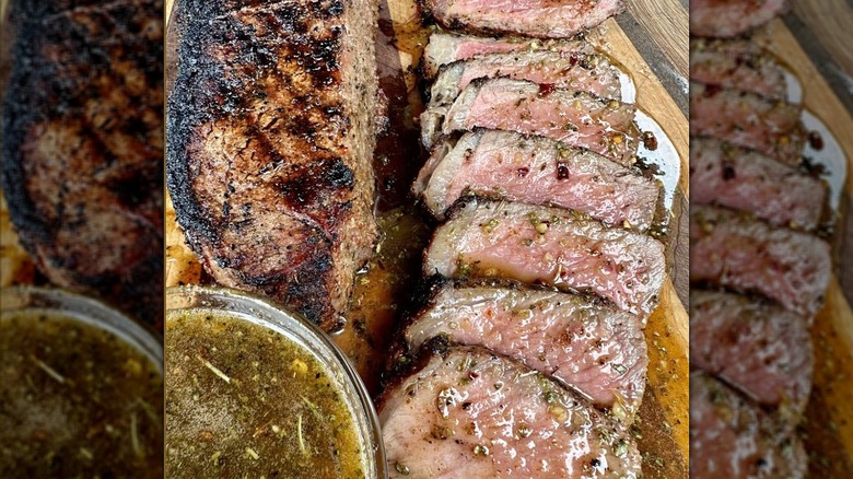 Cajun honey butter sauce poured over sliced steak and a bowl of it on the side.