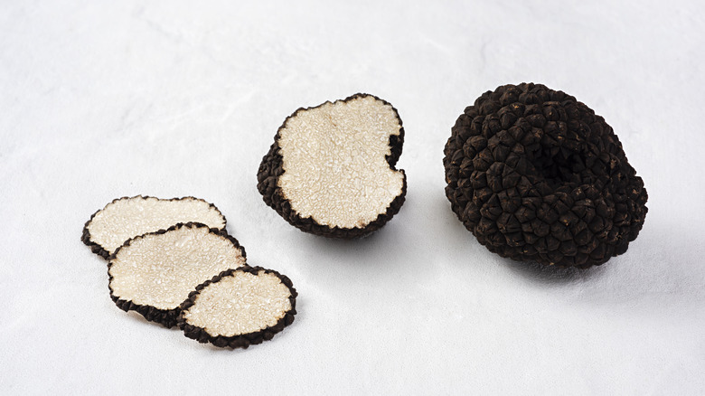 sliced black truffle white background