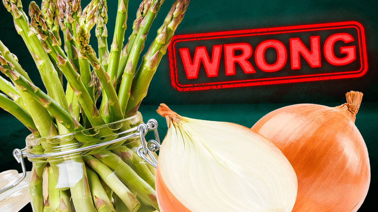 Asparagus in a jar on the left, a sliced in half onion on the right