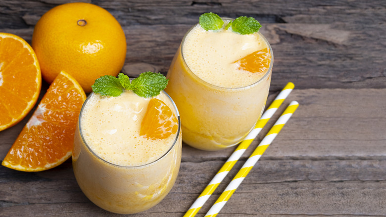 Orange smoothies garnished with mint