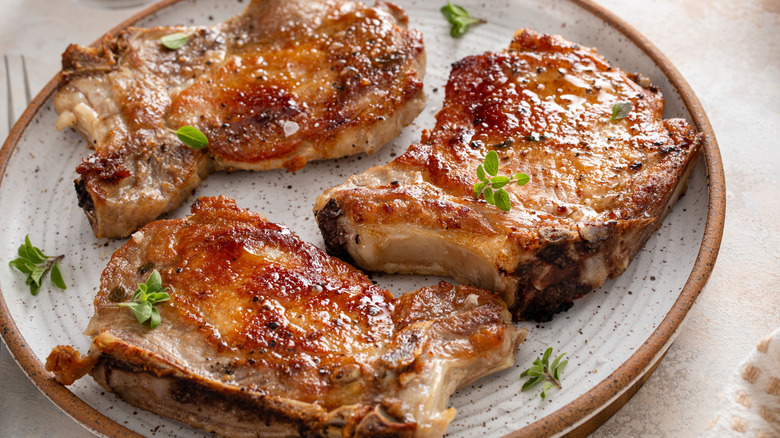 grilled pork chops on a ceramic plate