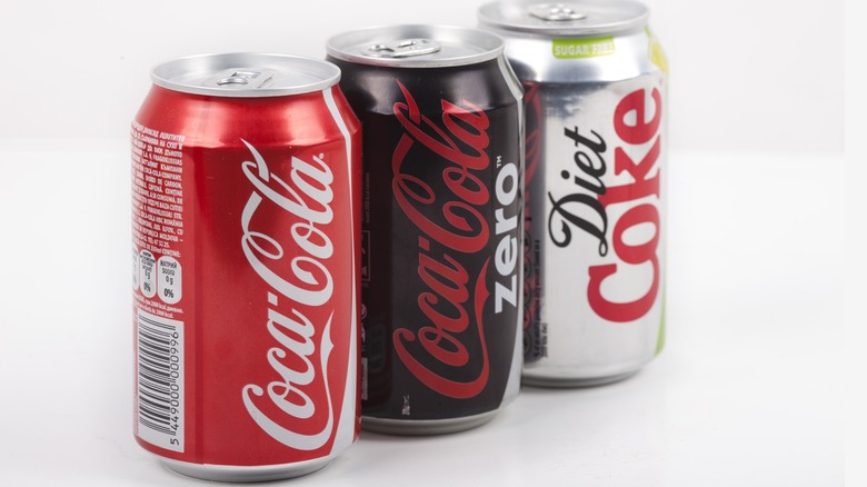 A variety of Coca Cola cans