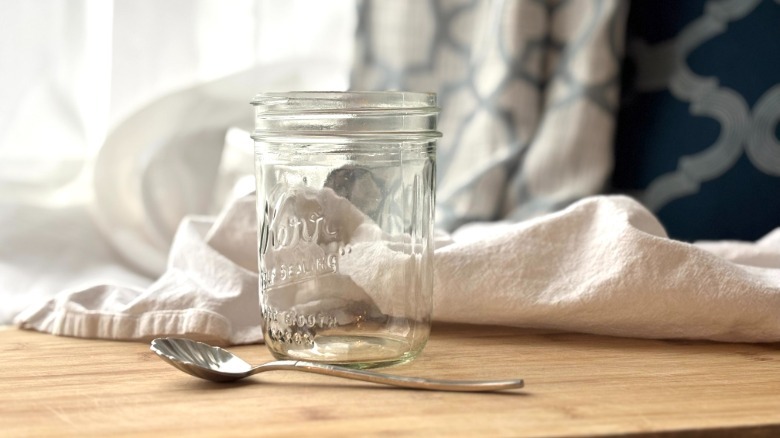 glass jar with spoon by window