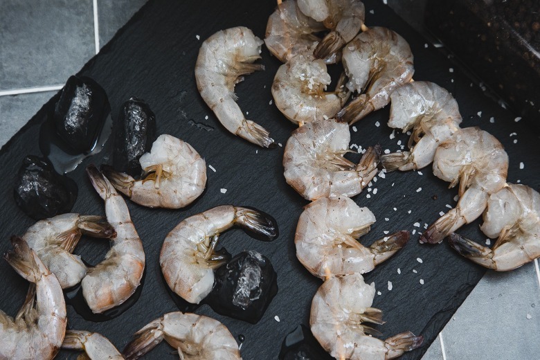 Shrimp with salt on slate board