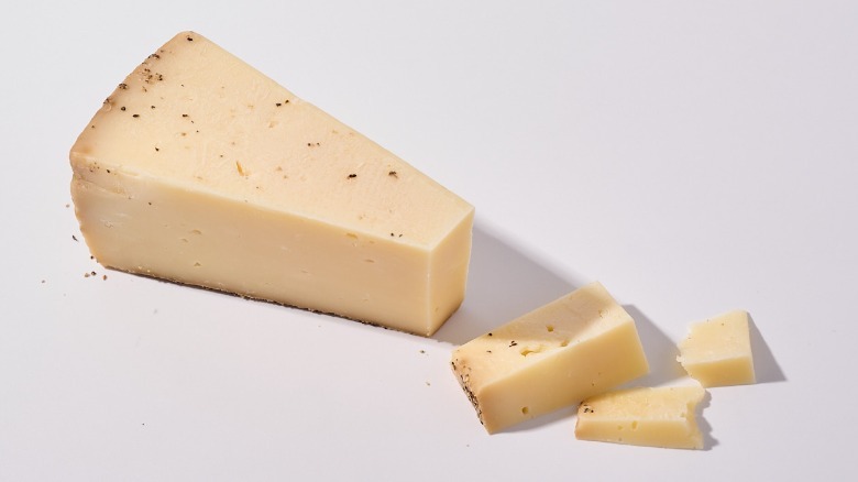 Toscano cheese sliced on a table