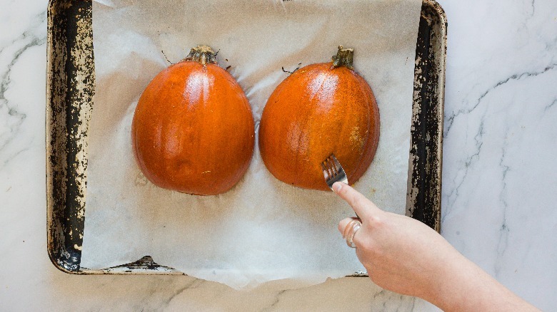 Poking pumpkin with a fork