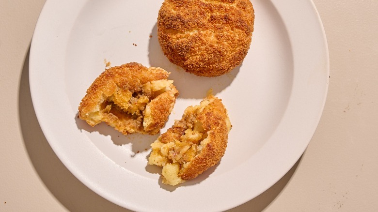 papas rellenas broken in half on a plate