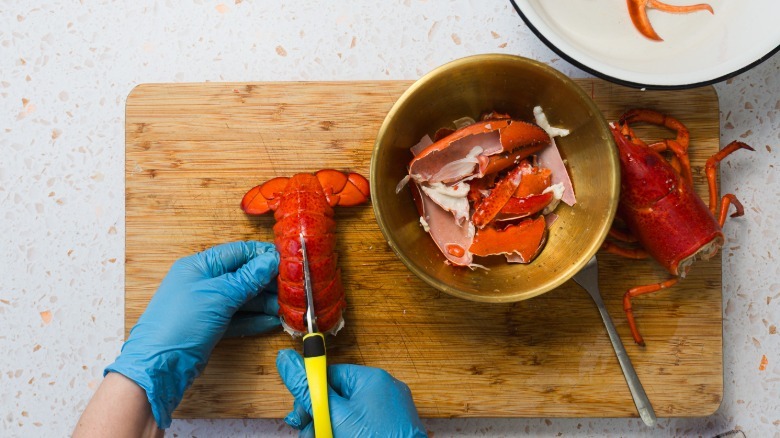 Cutting through the lobster tail shell