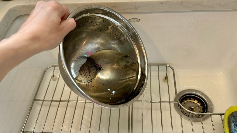 pouring dirty water down drain