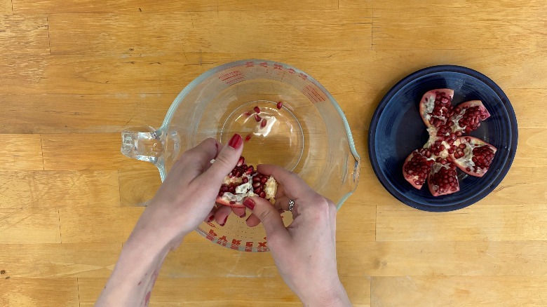 Pomegranates falling into bowl
