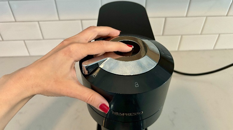 Nespresso button being pushed