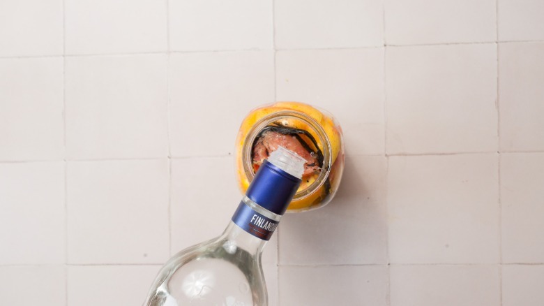 pouring vodka into jar