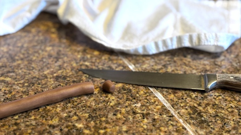 cutting 1-centimeter pieces of boba dough off snake