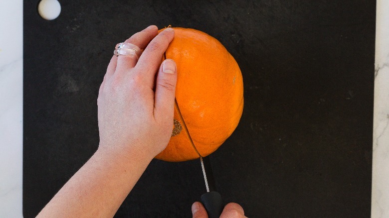 cutting a pumpkin