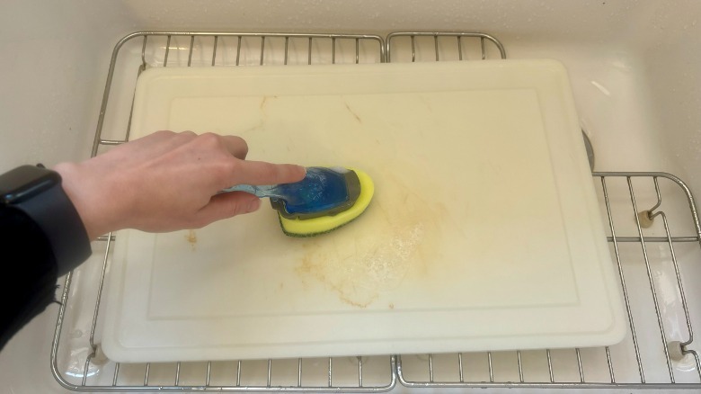 sponge scrubbing cutting board