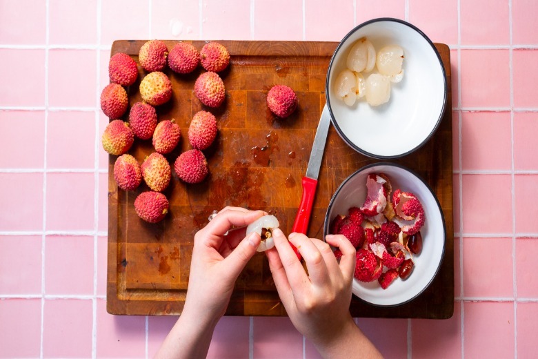 Removing the pit from a lychee