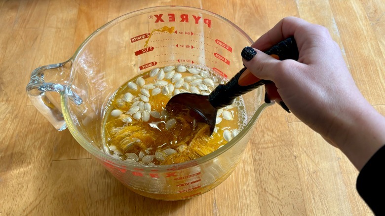 Pumpkin seeds stirred in water