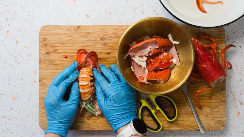 Pulling the tail meat out of the lobster