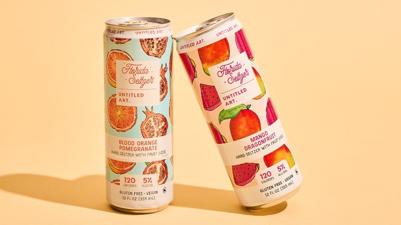 Two Untitled Art cans on a table