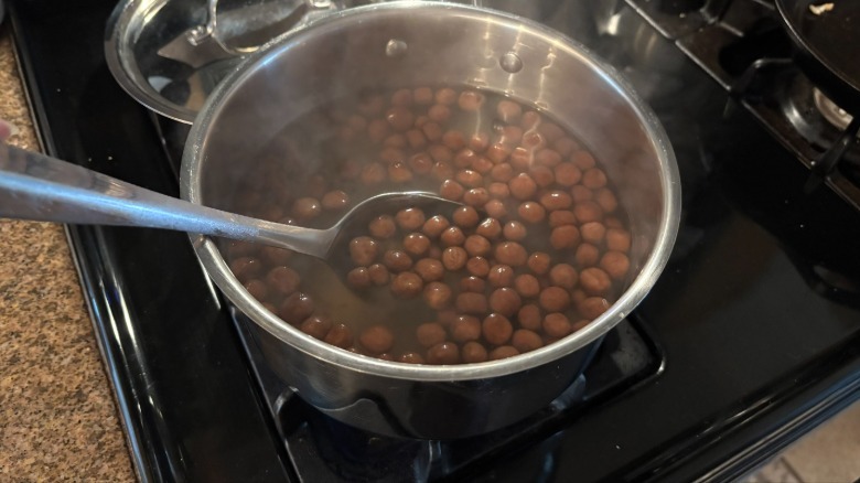 stirring boba pearls while they simmer