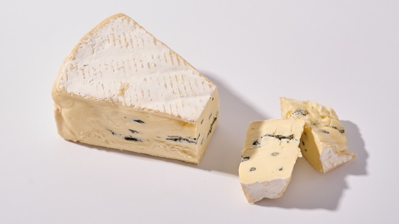 Cambozola cheese sliced on a table