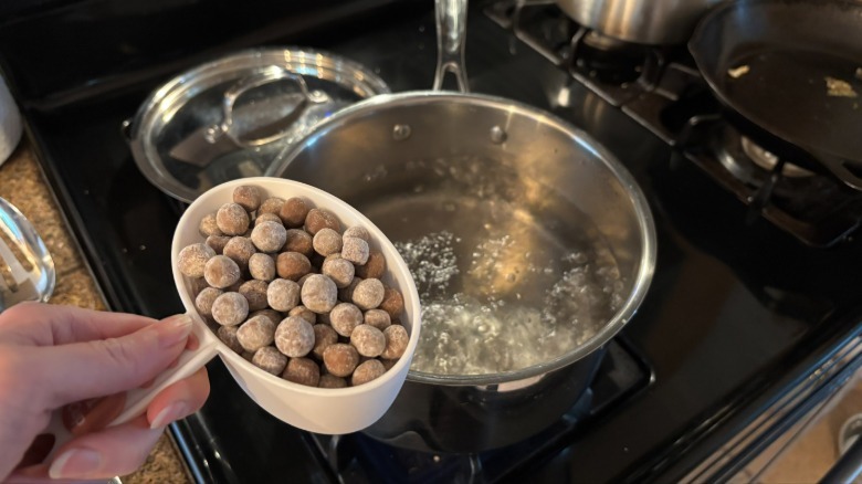 adding boba pearls to boiling water
