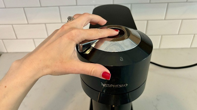 Nespresso button being pushed