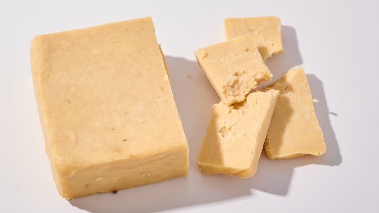 Slices of cheddar cheese on a table