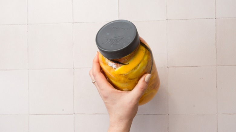 Hand holding jar